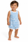 A smiling toddler standing barefoot against a white studio background, wearing a sleeveless light blue and white gingham romper with small white cloud motifs and white trim.