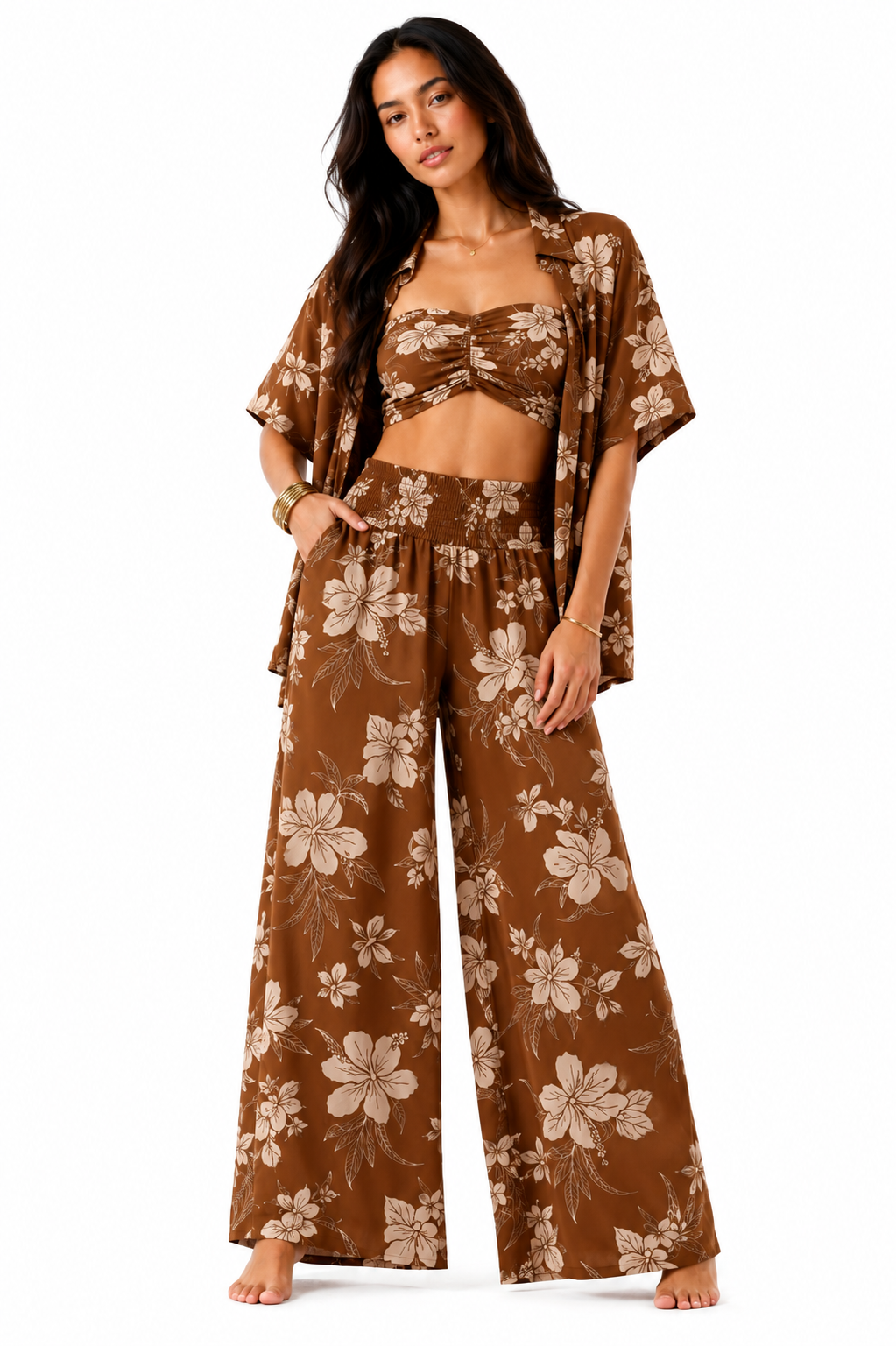 A woman modeling a matching brown floral lounge set consisting of a bandeau crop top, wide-leg pants, and a short-sleeve open-front cover-up, set against a plain white background.